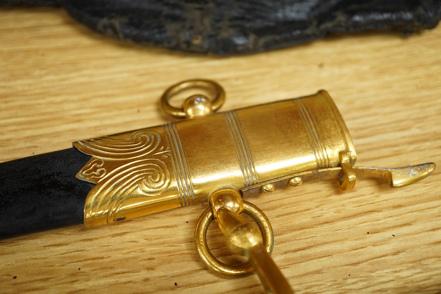 A post 1901 British naval officer’s dirk, the locket engraved with owners initials ‘CHCO’R’, regulation gilt brass mounts, with wire bound fish skin grip, bullion dress knot, in its original scabbard, blade etched with c